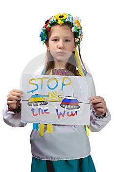 A little Ukrainian girl with tearful eyes holds a drawing with the inscription