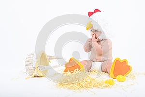 Little upset boy in a chicken costume with wicker basket