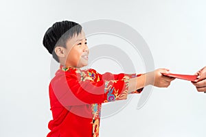 Little Vietnamese boy holding red envelops for Tet. The word mean double happiness. It is the gift in lunar new year or Tet