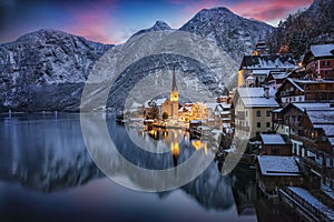 The little village of Hallstatt, Austria, during winter dusk time with snow