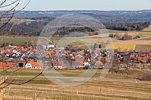 Little village in the middle of the german countryside with forests, fields and meadows