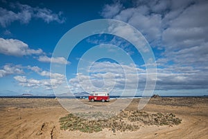 Little vintage red van parked near the ocean