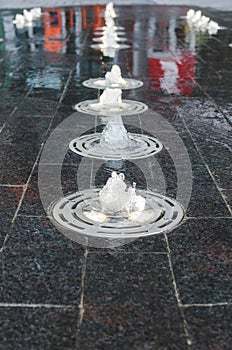 Little water fountains on the sidewalk at True North Square in downtown Winnipeg, Manitoba, Canada