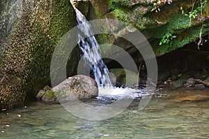 Little waterfall among the rocks of mountain creek