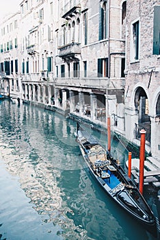 Little waterways in venice with empty gondola