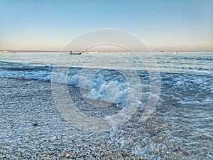 Little wave foam and beach blue sky