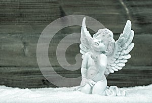 Little white angel in snow. Christmas decoration