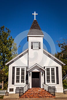 Little white country church with blue skies.