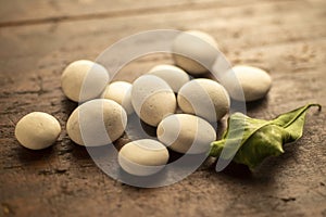 Little white fluvial stones on wooden surface