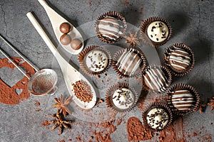 Little white and milk chocolate cupcakes on a dark table