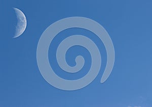 A little white moon in the middle of the sky