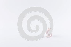 little white toy bunny on white