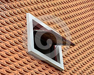 Little window at pattern orange brick cement wall.