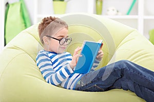 Little wise boy reading from book