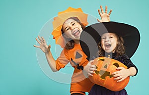 Little witch and pumpkin on turquoise background