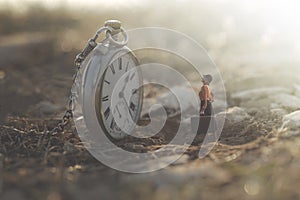 Little woman looks amazed at the big clock