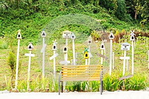 Little wooden bird house with label in garden