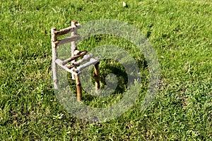 Little wooden chair on green grass