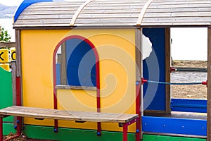 A little wooden house for kids in a children`s playground in a public park Umbria, Italy