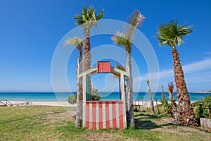 little wooden kiosk between palm trees next to Valdevaqueros Beach in Tarifa photo