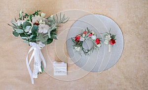 Little wreathe, boutonniere and wedding bouquet made of roses an