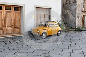 Little yellow compact Italian car