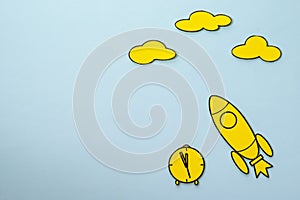 Little yellow rocket speeding through space blue sky background