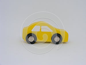 A little yellow toy wooden car isolated