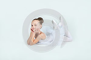 Little young ballerina poses on camera