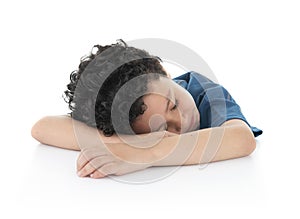 Little Young Exausted Lazy Boy Fell Asleep on White Table, Studio Shot, Isolated on White Background photo