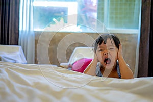 Little young girl screaming and covering ears