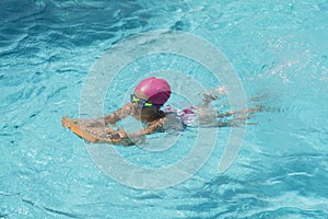 Little Young Girl Swimming in a Pool