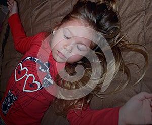 Little young kid closed her eyes, praying, dreaming in bedroom