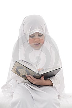 Little Young Muslim Girl Reading Quran photo
