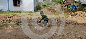 Littleboy  try to hit the ball with ball in hand, in small village in Gujarat, India