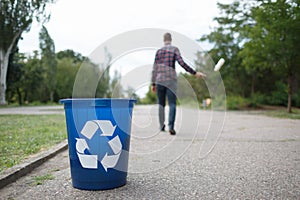 Litttering male. An empty of plastic drinking bottle littering on the road floor. Concept of environmental protection.