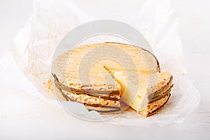 Livarote cheese on white. Soft French cow`s milk cheese from Normandy
