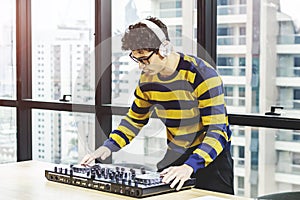 Live concert event deejay party, One man DJ show EDM music city background. Portrait Professional Performance DJ Man