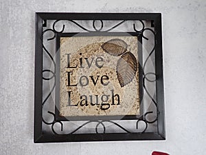 LIVE, LAUGH, LOVE... inspiration sign with two leaves