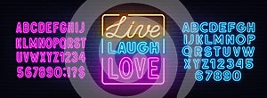 Live laugh love neon quote on brick wall background.