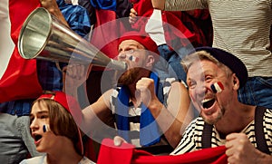 Live match. Football, soccer fans emotionally cheering up favourite france team. People wearing country& x27;s attributes