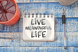 Live Meaningful Life, text words typography written on book against wooden background, life and business motivational