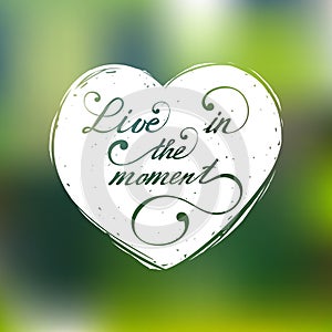 Live in the moment vector hand lettering inspirational typography poster in heart silhouette on blur background.