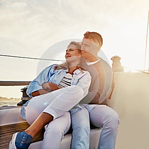 Live for the moments you cant put into words. a couple enjoying a boat cruise out on the ocean.