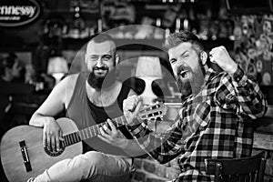 Live music concert. Man play guitar in pub. Acoustic performance in pub. Hipster brutal bearded with friend in pub