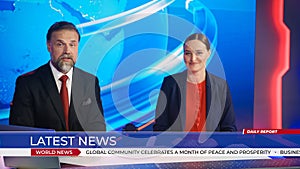Live News Studio with Beautiful Female and Handsome Man Anchors Start Reporting. TV Broadcasting C