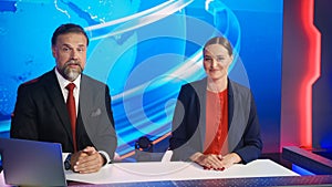 Live News Studio with Beautiful Female and Handsome Man Anchors Start Reporting. TV Broadcasting C