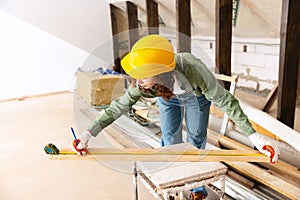 Live portrait of young woman, builder wearing helmet using different work tools at a construction site. Gender equality