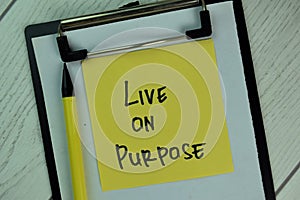 Live on Purpose write on sticky notes isolated on Wooden Table