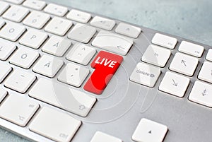 Live stream concept with keyboard and red key. photo